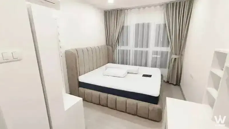 Modern 1-bed condo bedroom in Supalai City Resort Charan 91 with beige tufted bed and neutral tones