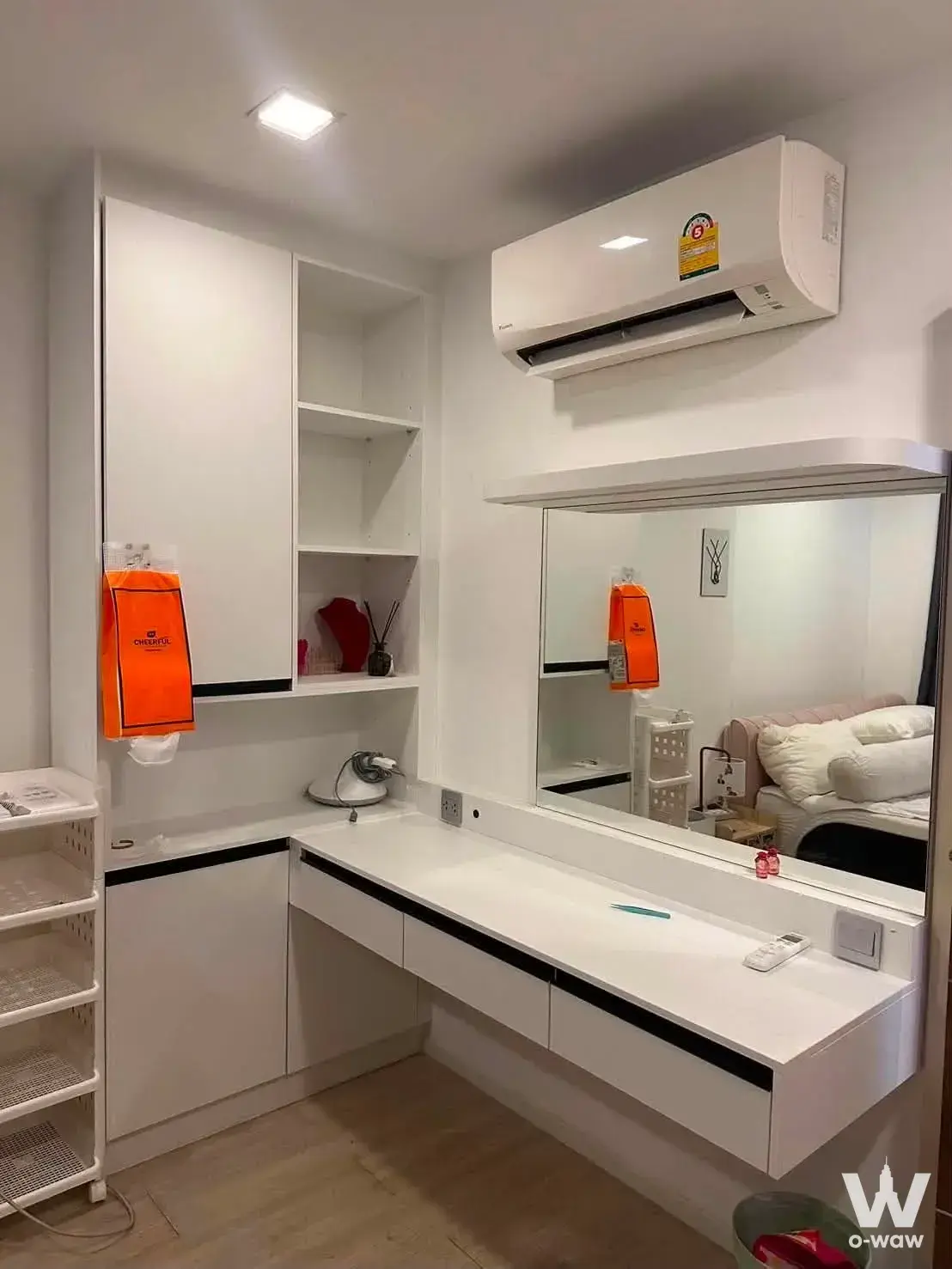 Bedroom dressing area in an Atmoz Ladprao 71 condo with built-in white cabinetry and a floating vanity desk