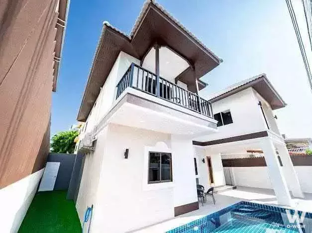 Modern two-story townhouse exterior with blue-tiled pool and balcony at Blue Lagoon Resort Hua Hin