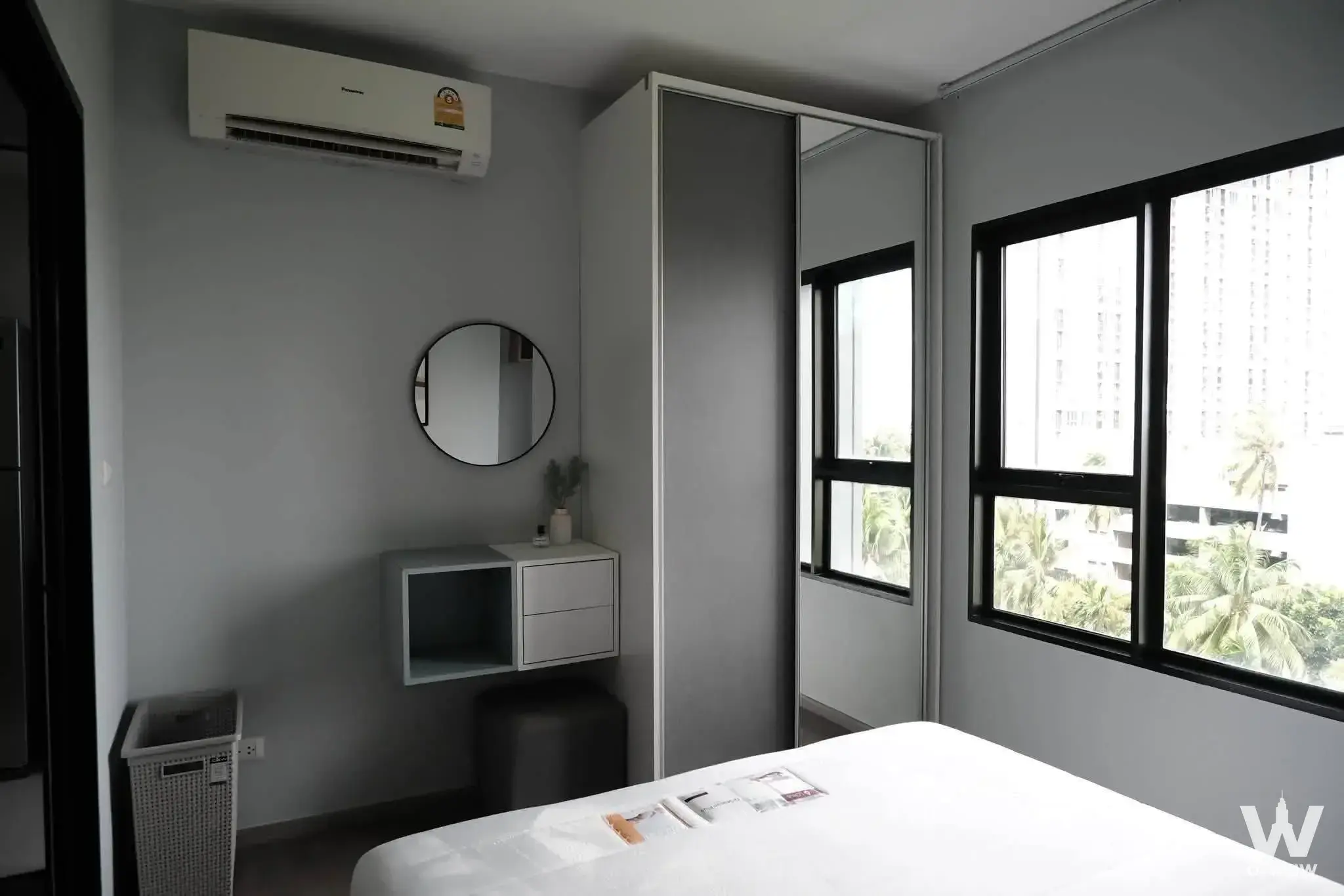 Bedroom with mirrored wardrobe and urban views in Aspire Sathorn-Taksin