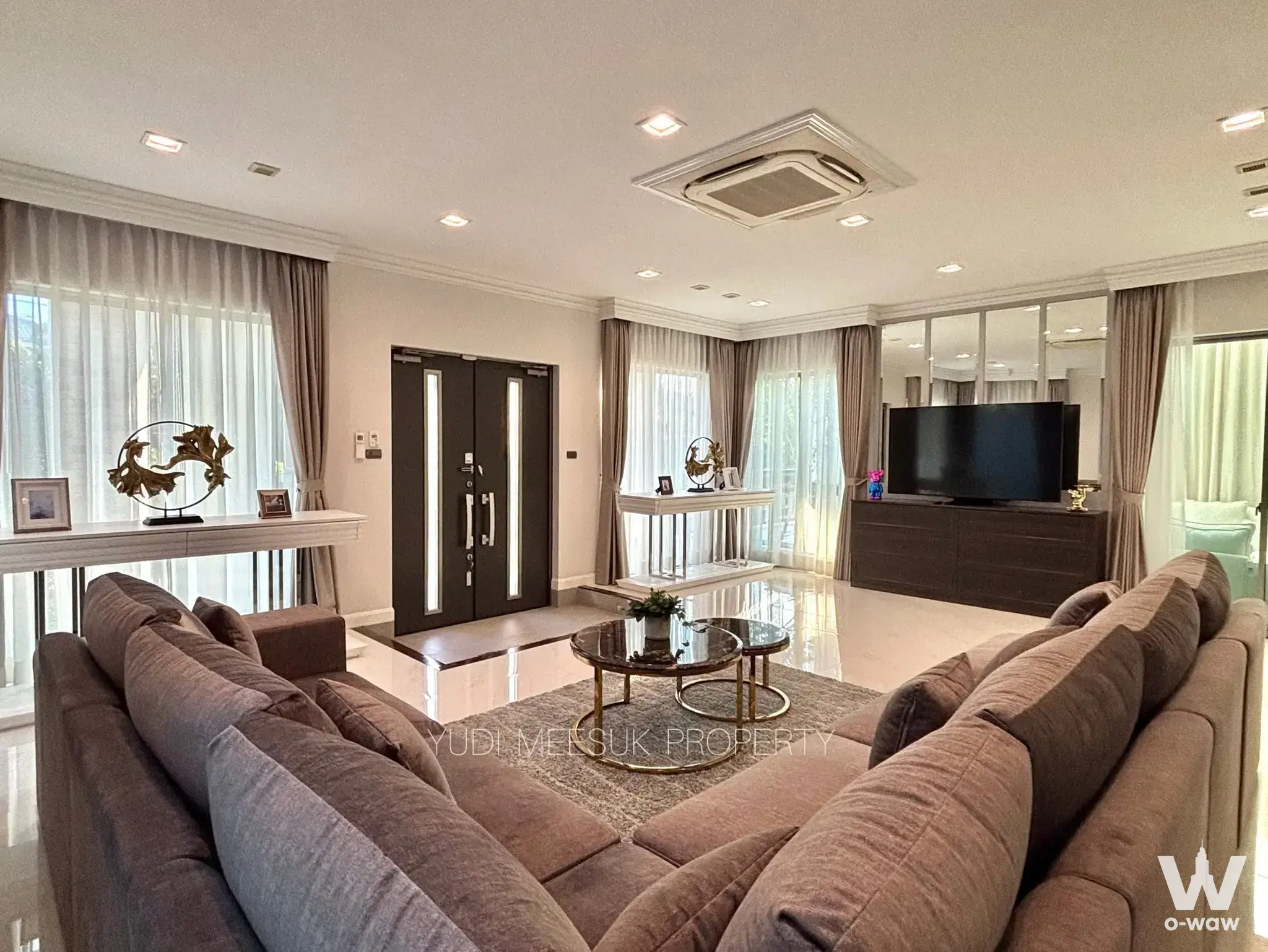 Spacious living room in Perfect Masterpiece Sukhumvit 77 house with taupe sectional sofa