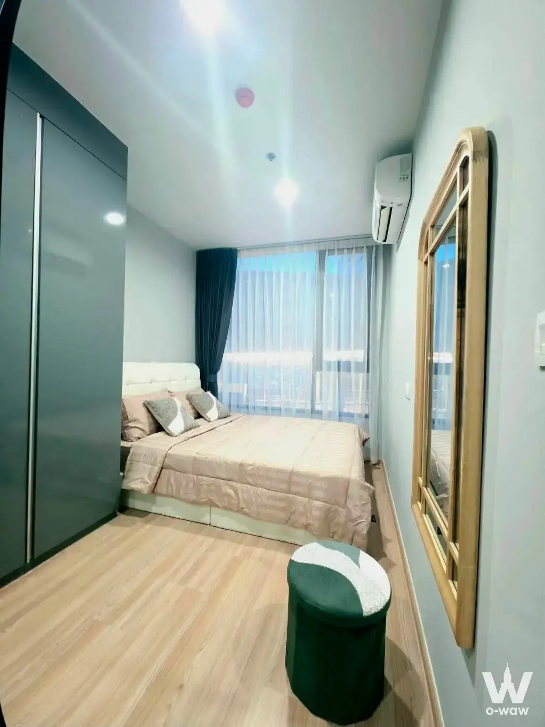 Modern 1-bed condo bedroom in Skyrise Avenue Sukhumvit 64 with dark-grey wardrobe and queen bed
