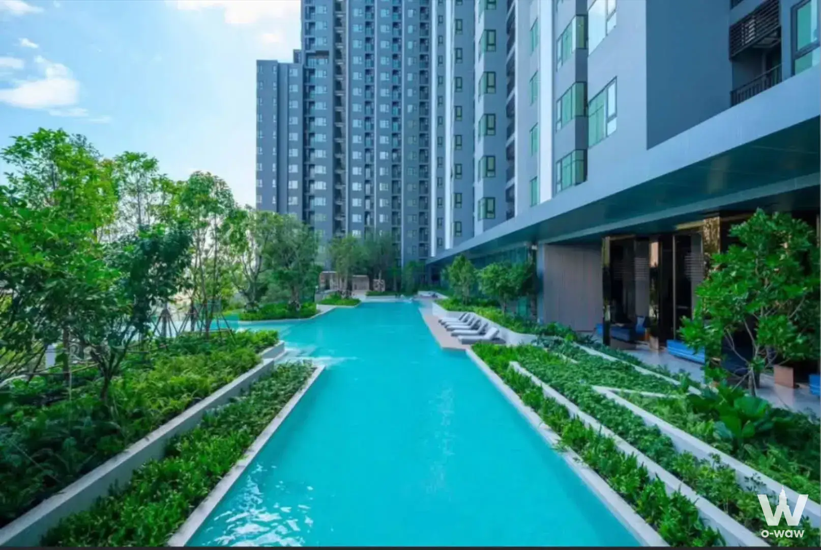 2-bed condo for rent in Life Sathorn Sierra showcasing outdoor turquoise lap pool surrounded by lush tropical landscaping