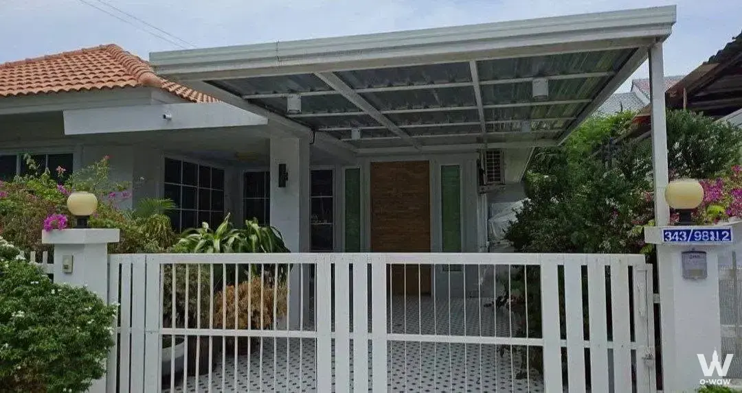 White facade home with terracotta roof and carport entrance in Siam Country Club Bangkok
