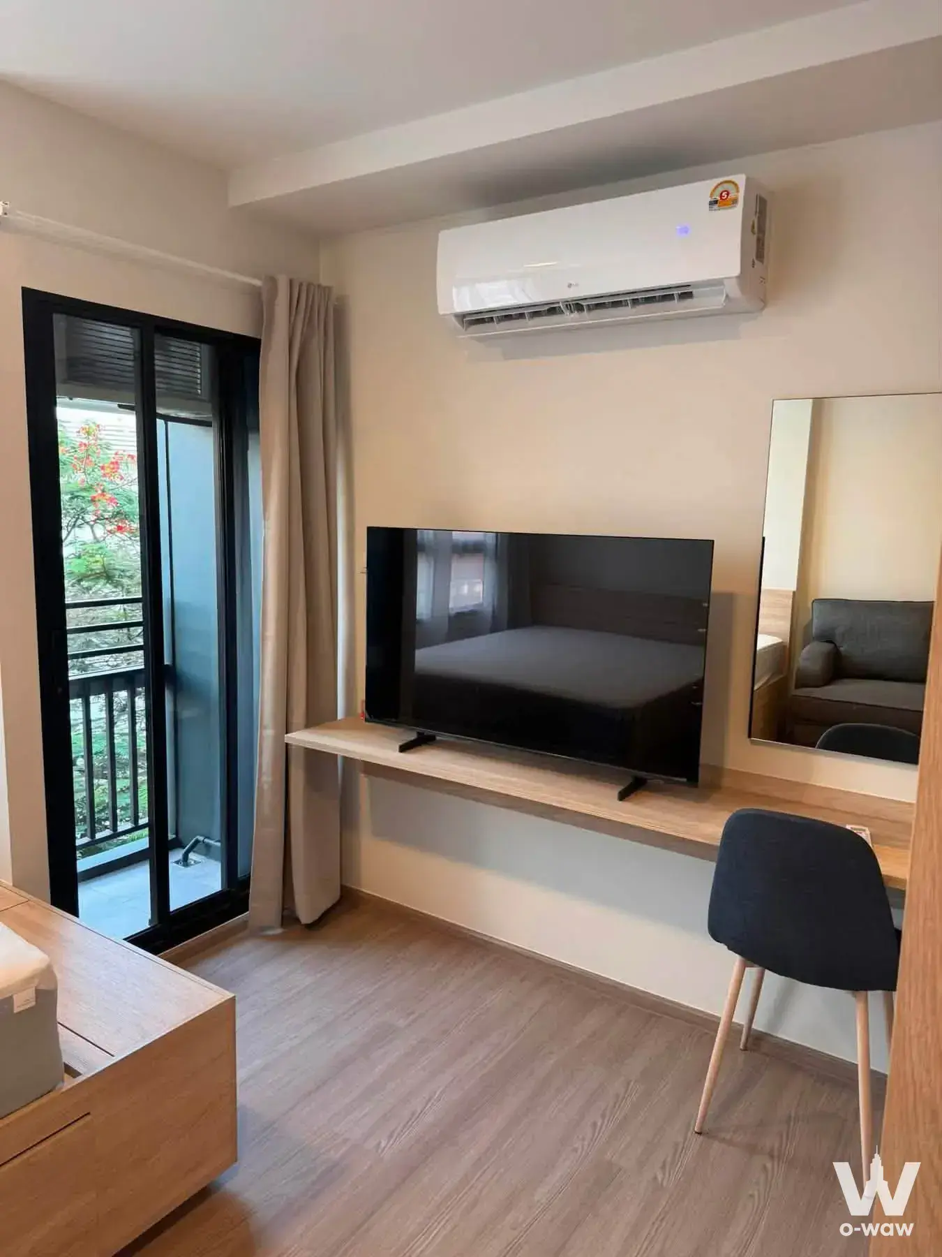 Bedroom workspace with desk and balcony access in a 1-bed condo for rent at The Muve Bangwa