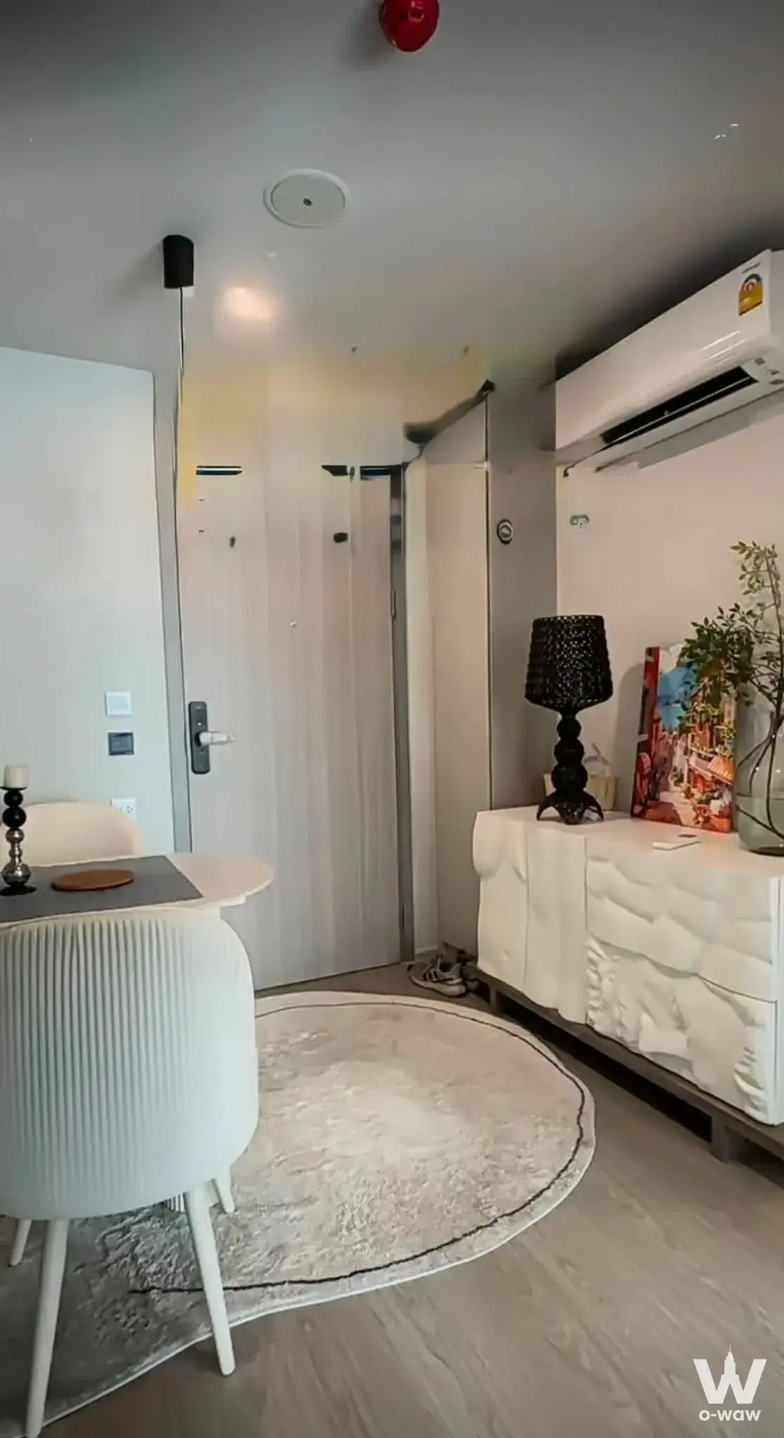 Entryway of 2-bed Atmoz Oasis Onnut condo with smart lock, shag rug, and modern sideboard