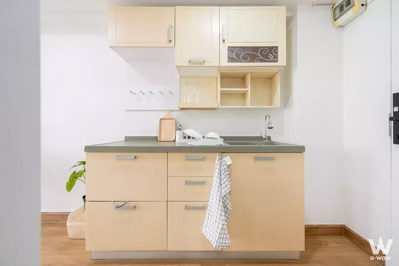 Compact kitchenette with beige cabinets and grey countertop in Waterford Royal Suites