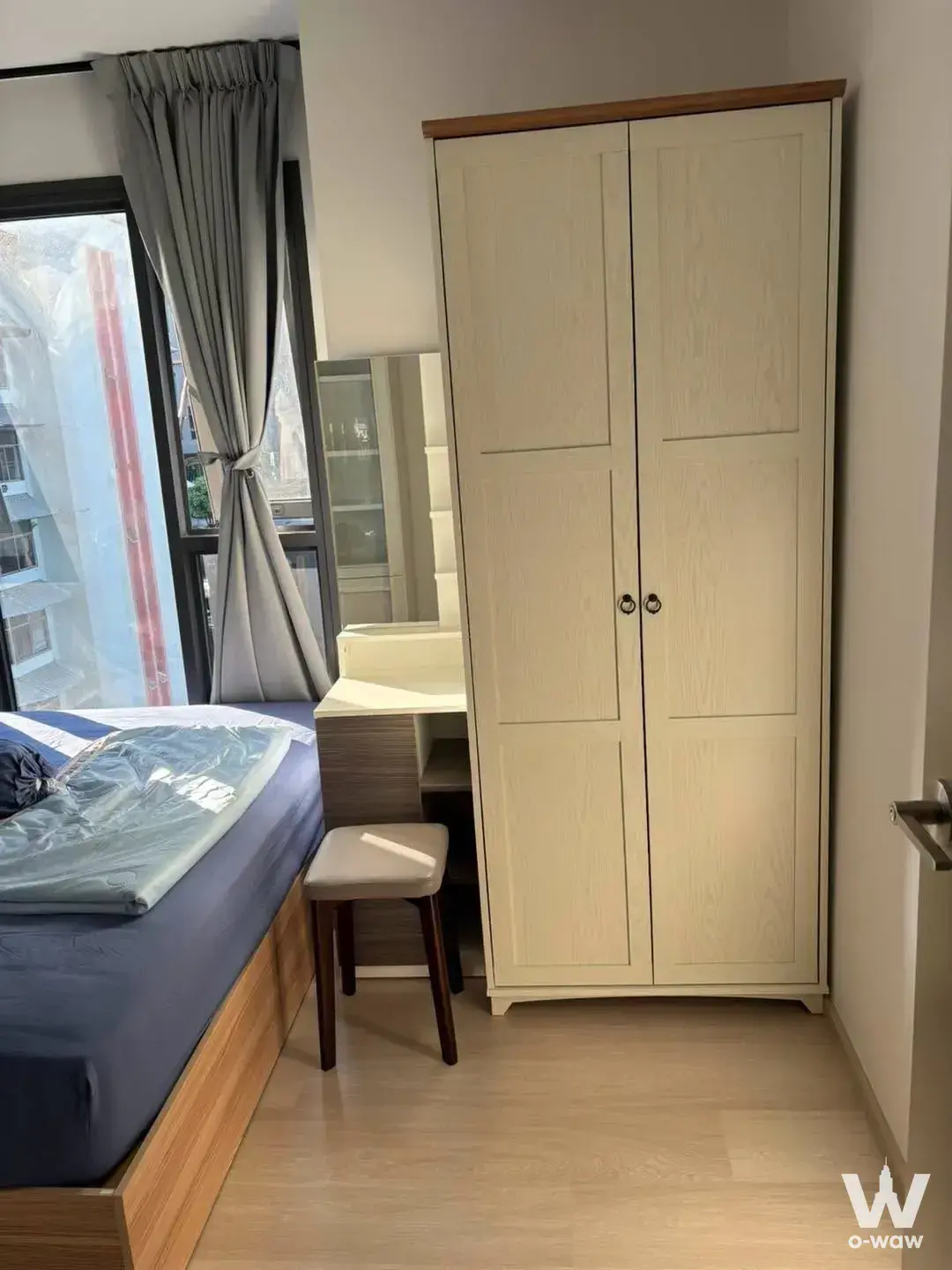 Compact bedroom in Aspire Vibha-Victory condo featuring single bed, built-in vanity, and tall wardrobe