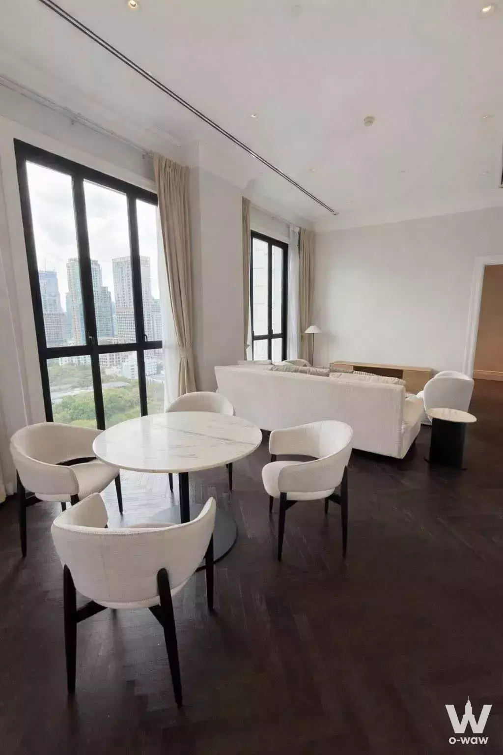 Spacious living and dining area with city skyline views in 2-bed 98 Wireless condo