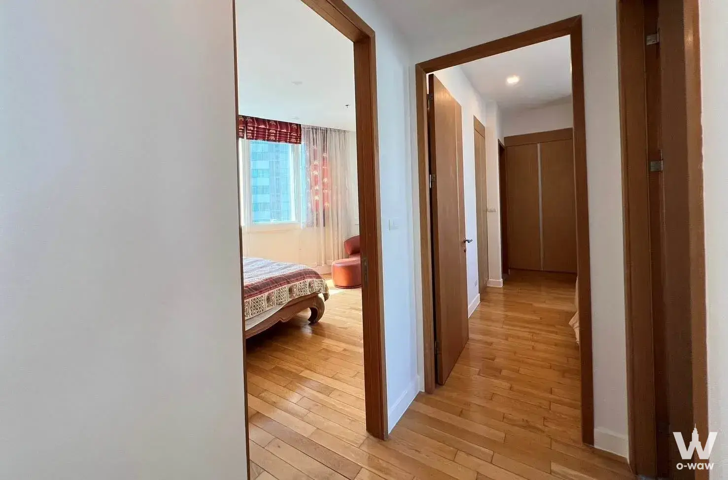 Bedroom with queen bed and city view in 2-bed Millennium Residence condo