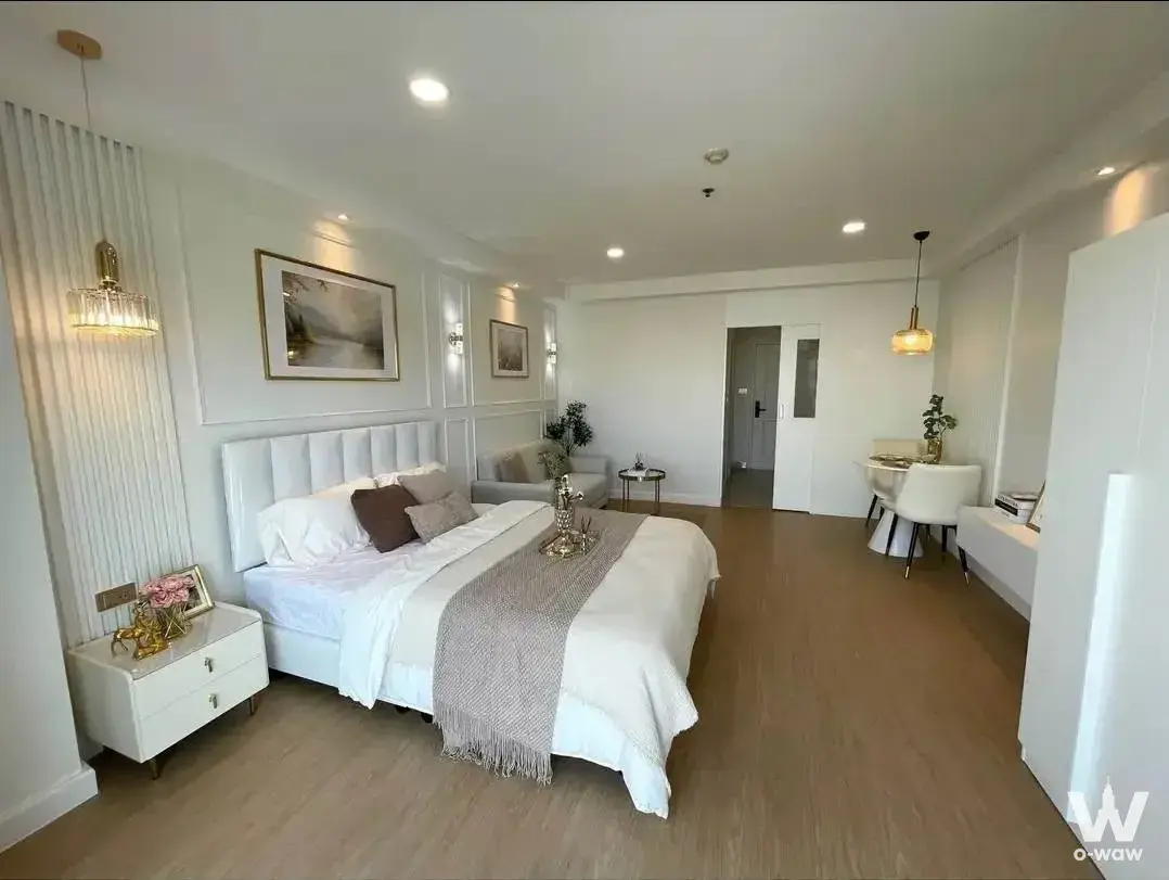 1-bed condo for sale in City Living Ratchada with white tufted headboard and gold accents