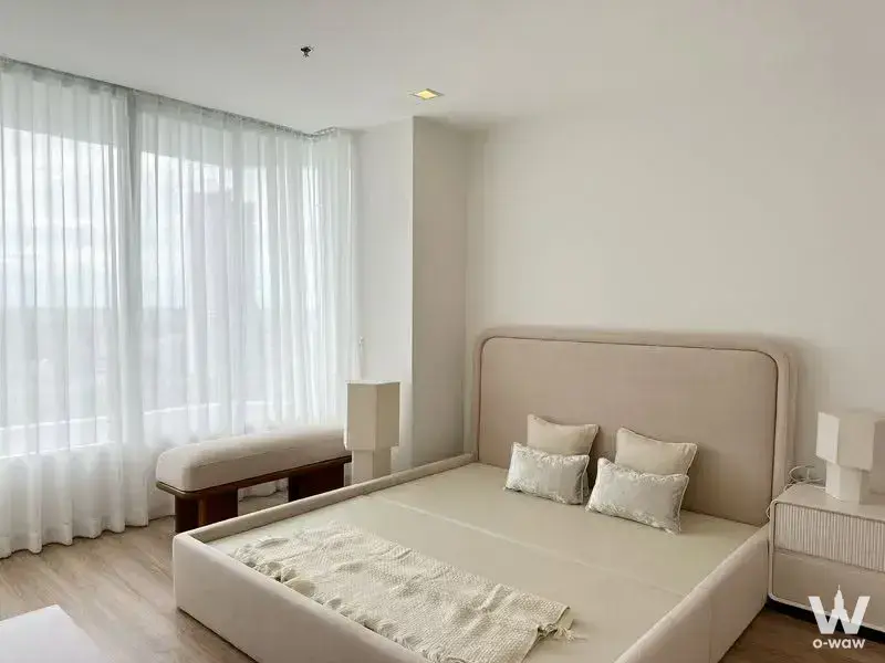 Master bedroom at My Resort @ River with beige platform bed and floor-to-ceiling curtains