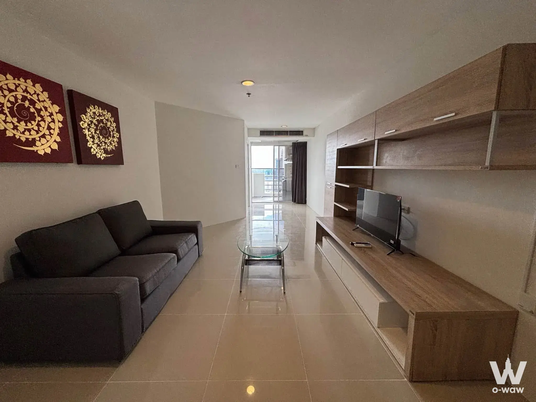 Dark-grey sofa and red mandala art in a furnished Waterford Diamond Tower living room