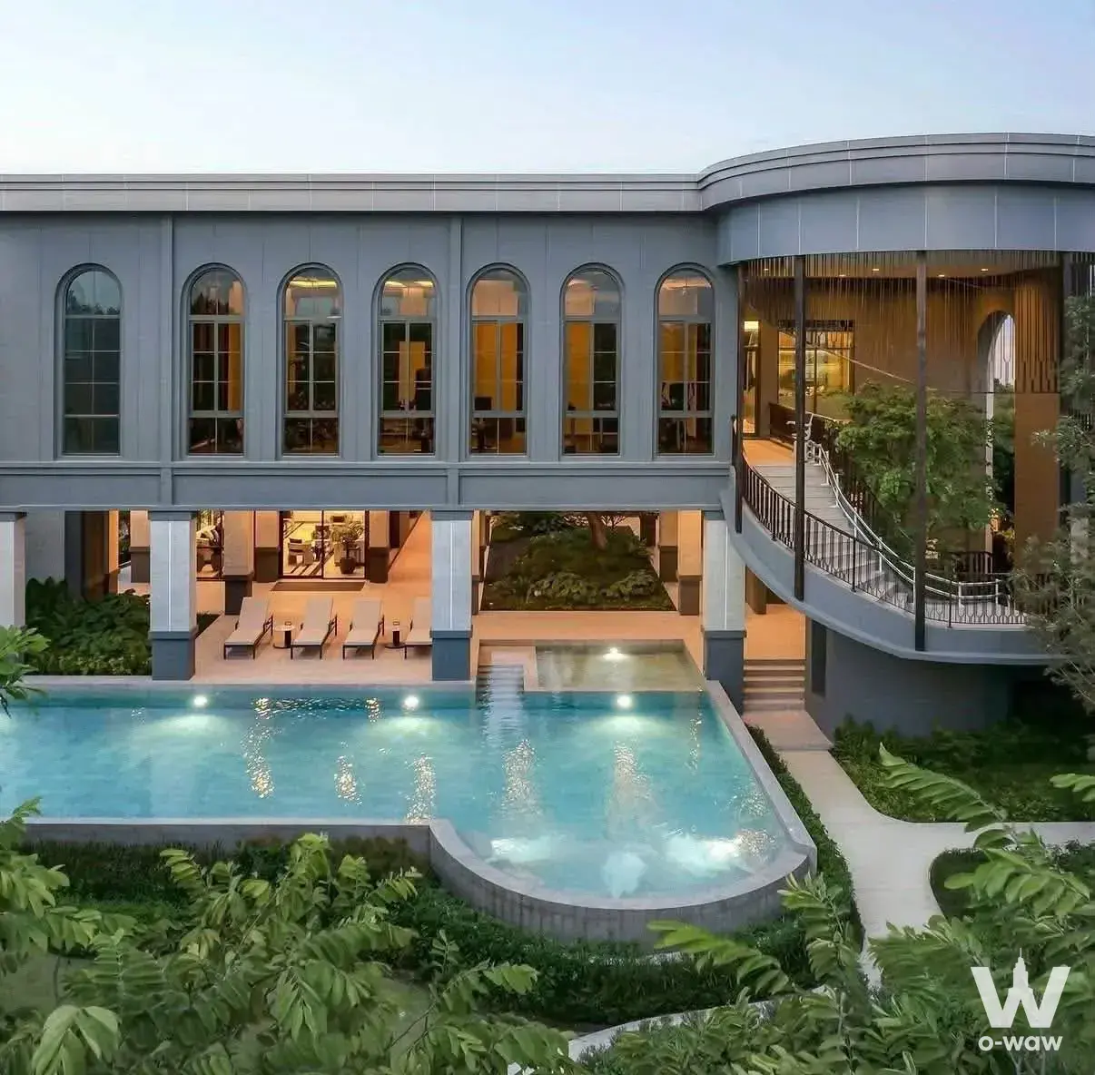 A Grand Bangkok Boulevard 0-bed house for sale has arched windows and a lit pool at twilight