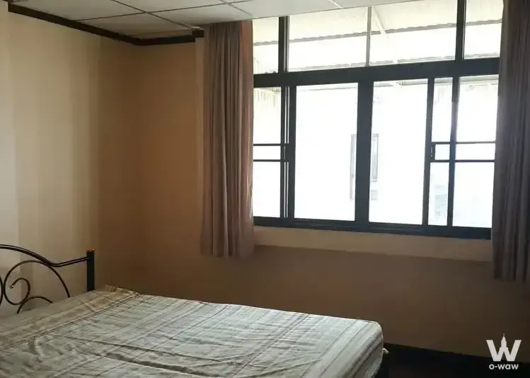 Basic furnished bedroom with scroll headboard and security bars in Fair Tower Condominium 2-bed condo for sale