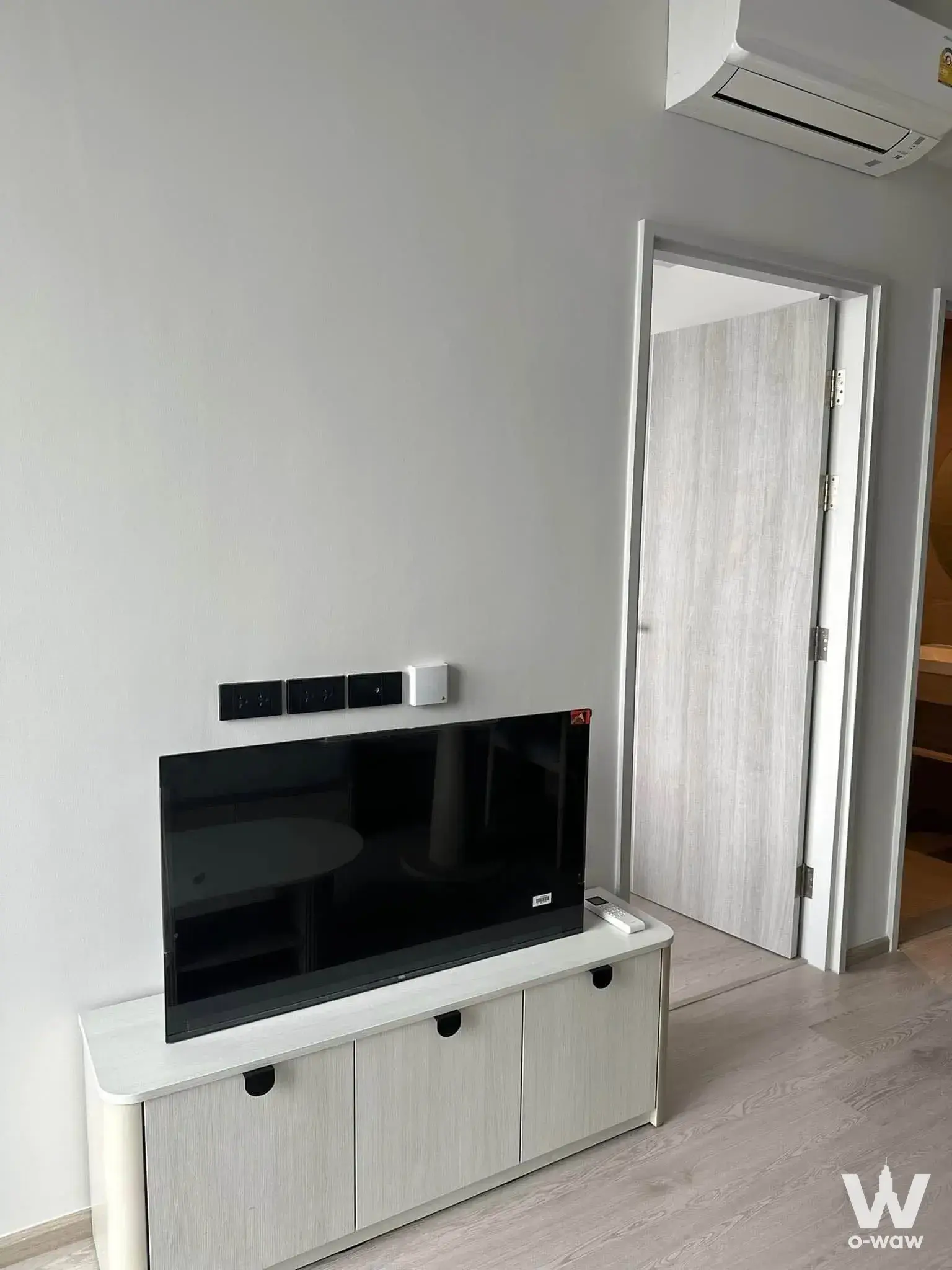 Living room corner in Reference Sathorn-Wongwianyai with a flat-screen TV on a low media console