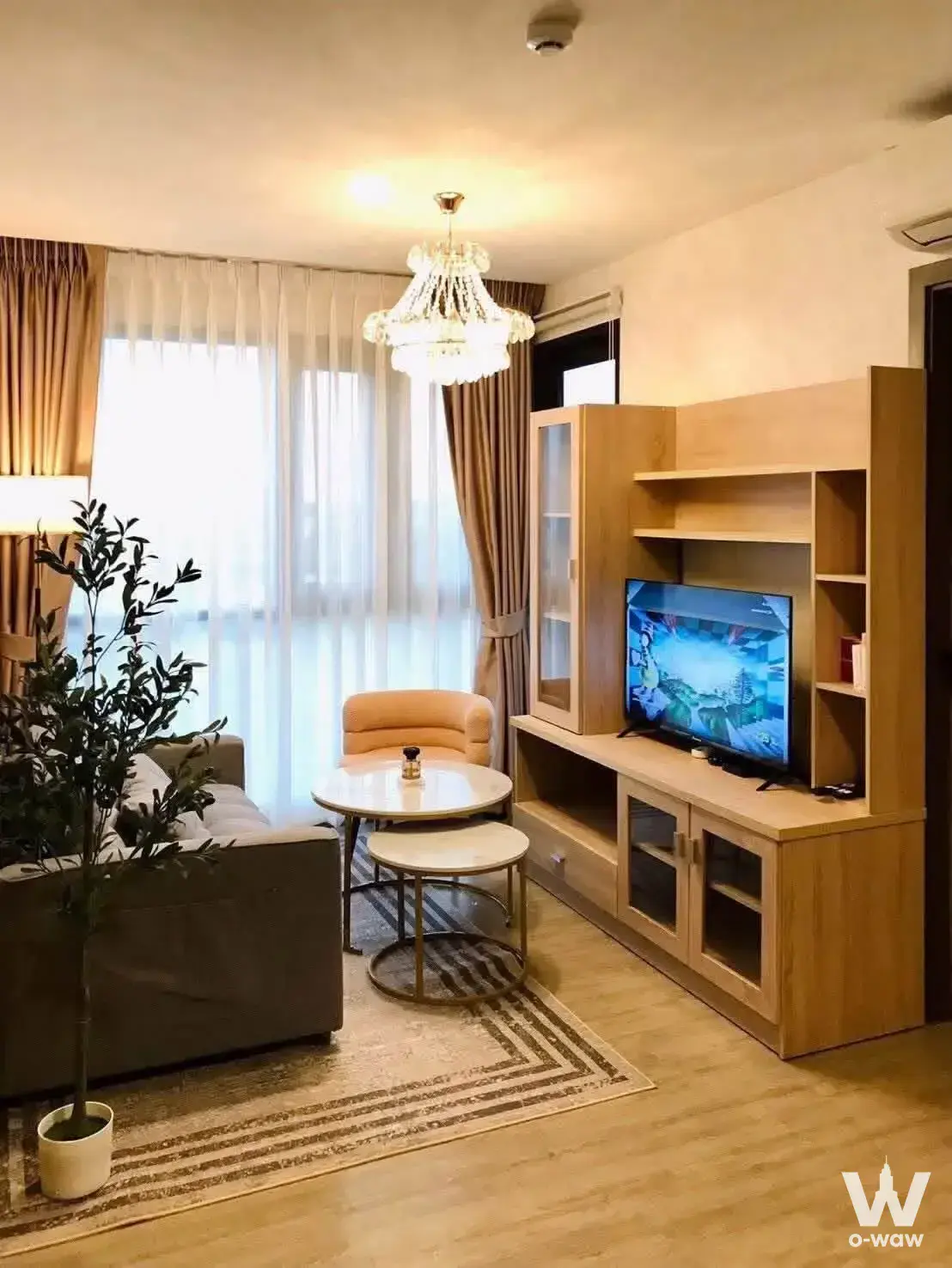 2-bed condo for rent in VIVERE By Very Condo with light wood floors and a crystal chandelier