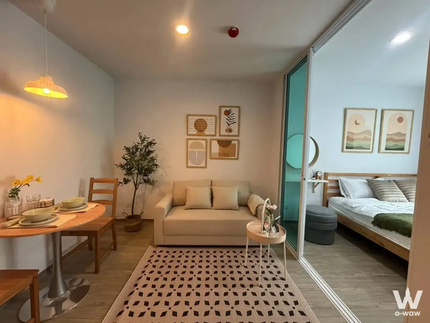 Open-plan living and dining area with yellow pendant lamp in Regent Home 18 1-bed condo