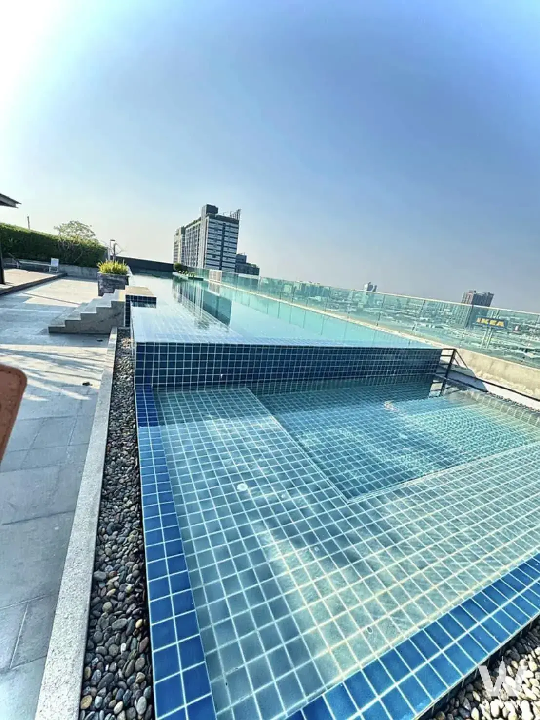 Rooftop infinity pool with blue tiles at A Space Me Bangna condo