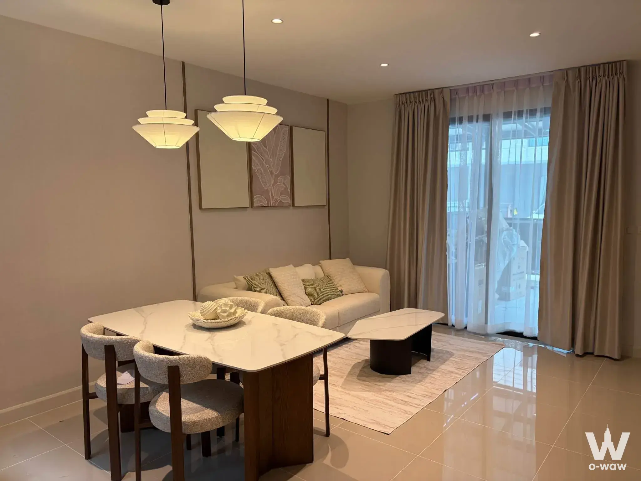 Furnished living room in a 3-bed house for rent at Pleno Sukhumvit-Bangna 2 with cream sofa and marble table