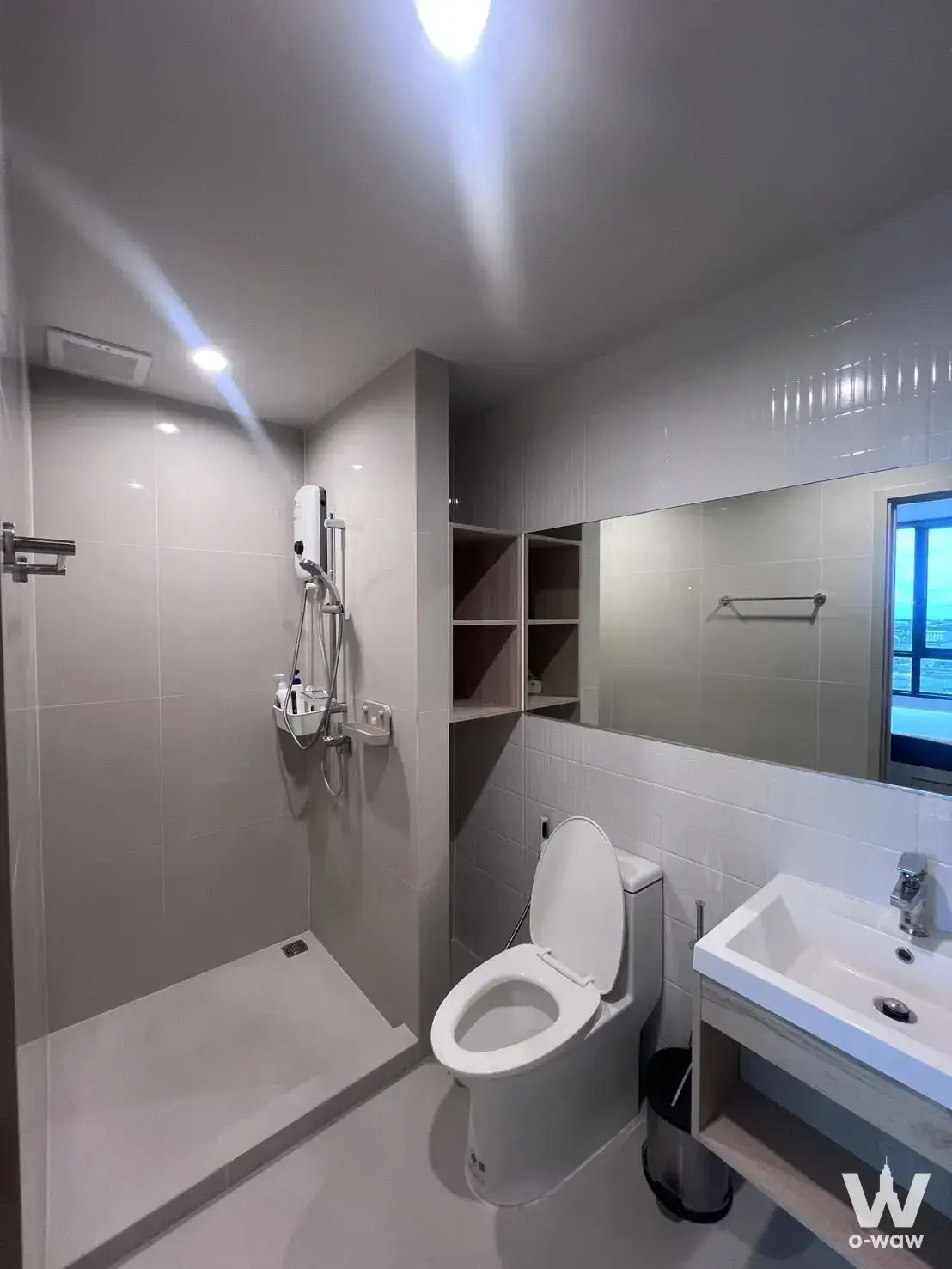 Modern bathroom with walk-in shower and wood vanity in Nue Mega Plus Bangna 1-bed condo