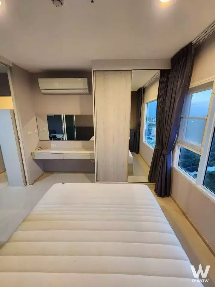 Modern 1-bed condo for sale in Aspire Erawan Prime with floor mattress, wardrobe, and city view