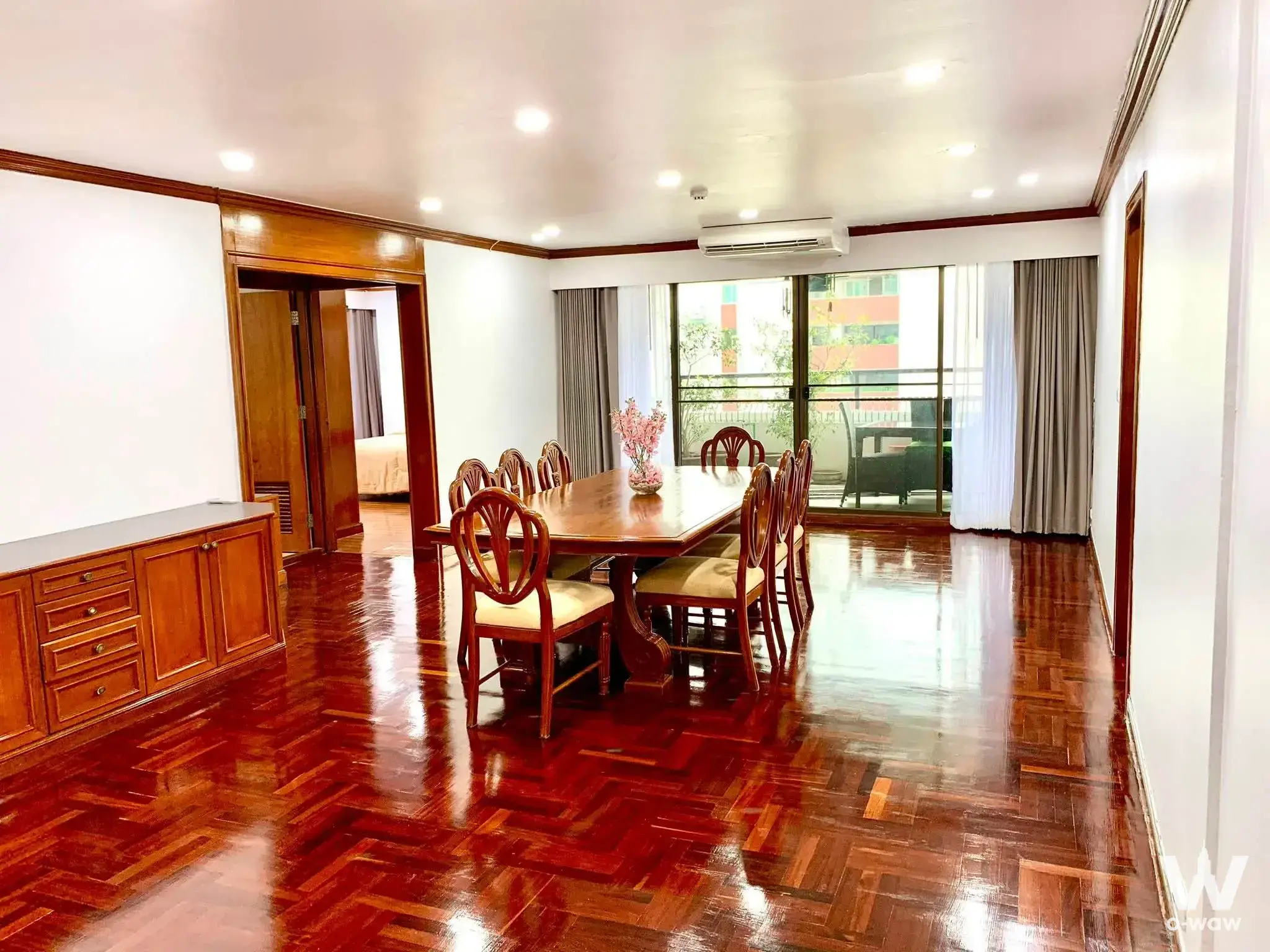 Dining room in a Liberty Park 2 condo featuring a herringbone wood floor and eight-seat solid wood table