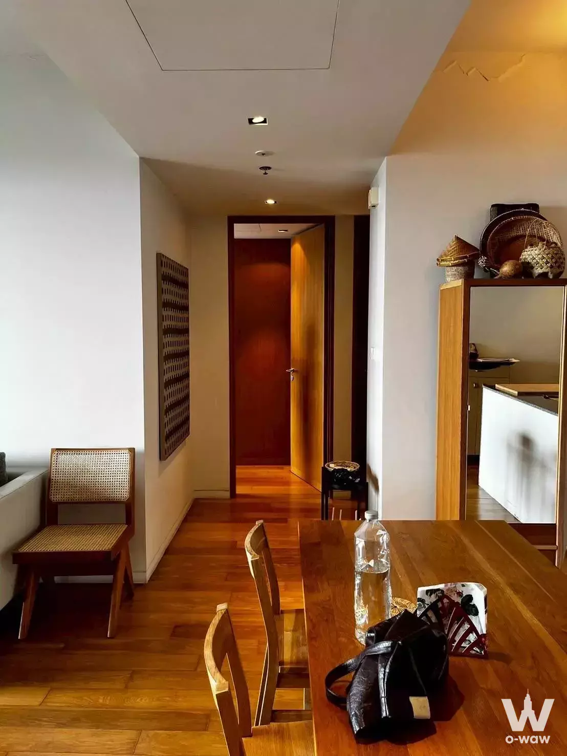 Dining area in 2-bed Met Condo rental with honey-toned hardwood floors and wooden table