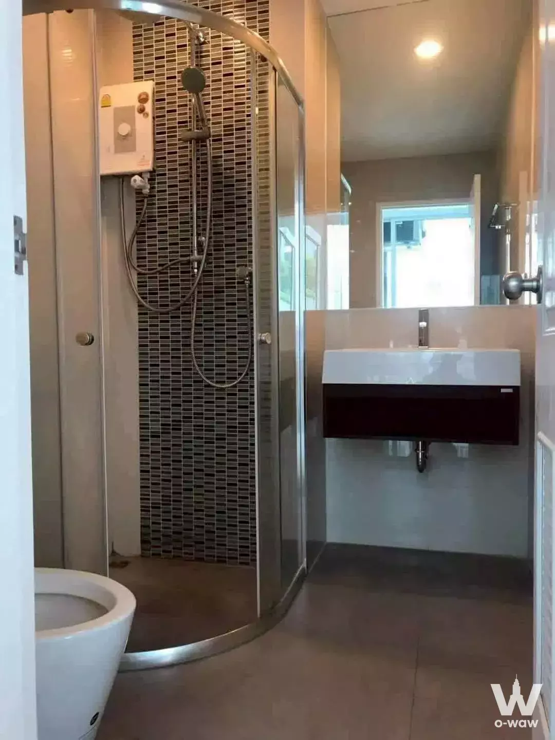Compact bathroom with mosaic-tiled shower and floating vanity in The Sky Sukhumvit condo