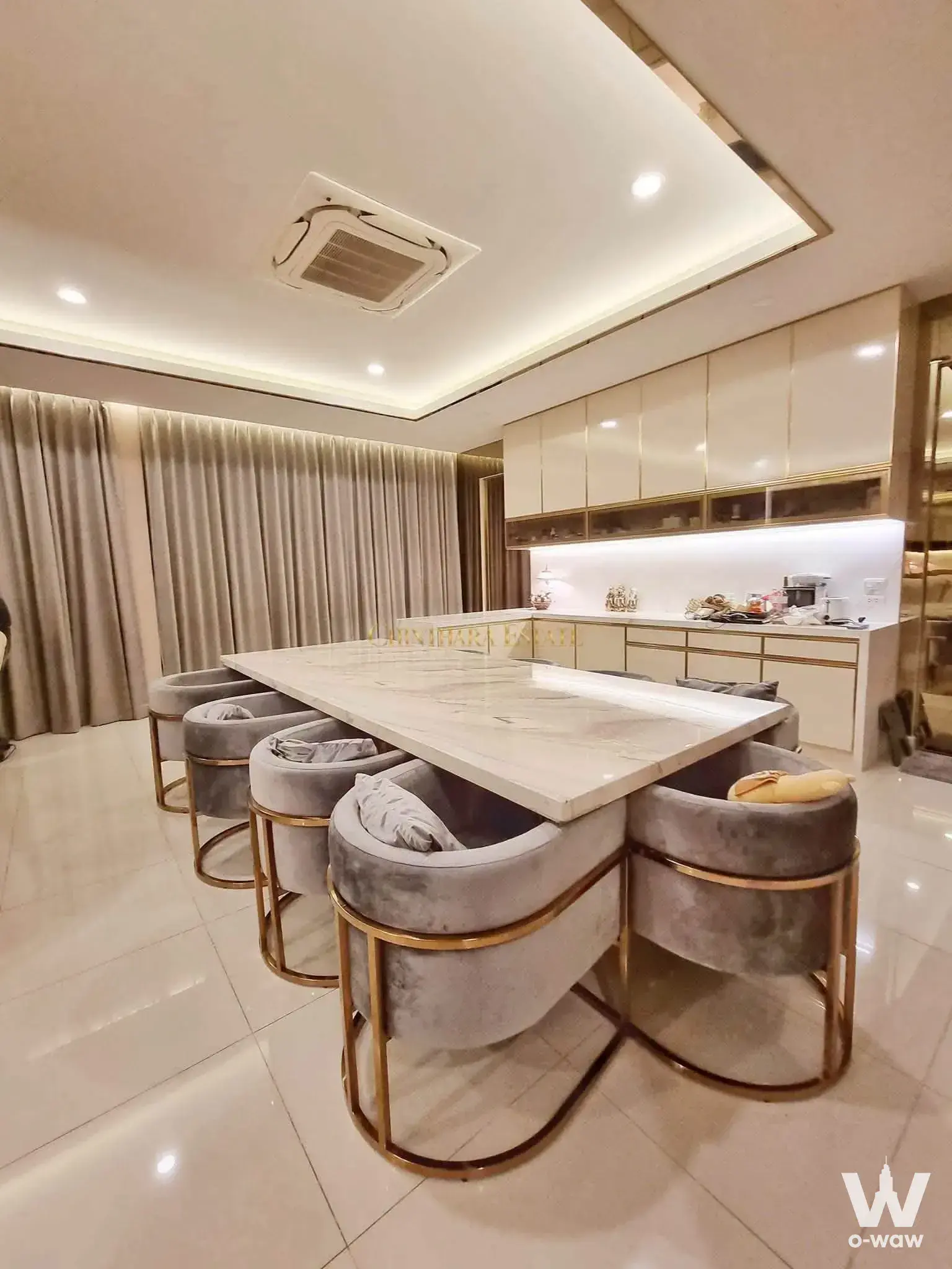 High-end dining area with white marble table and velvet chairs for sale in Ratchaphruek