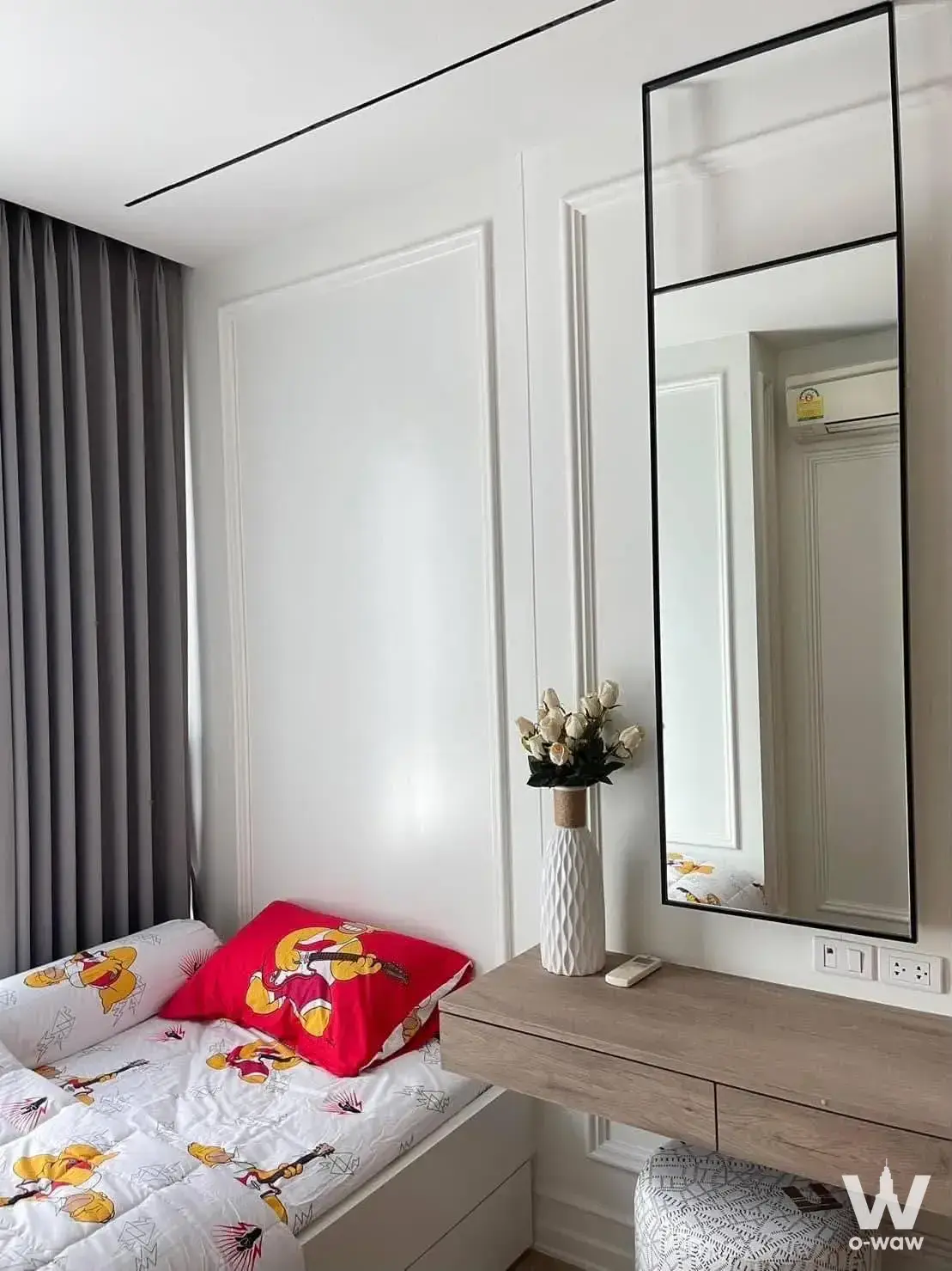 Bedroom with built-in single bed, floating vanity desk, mirror, and grey curtains in contemporary white interior