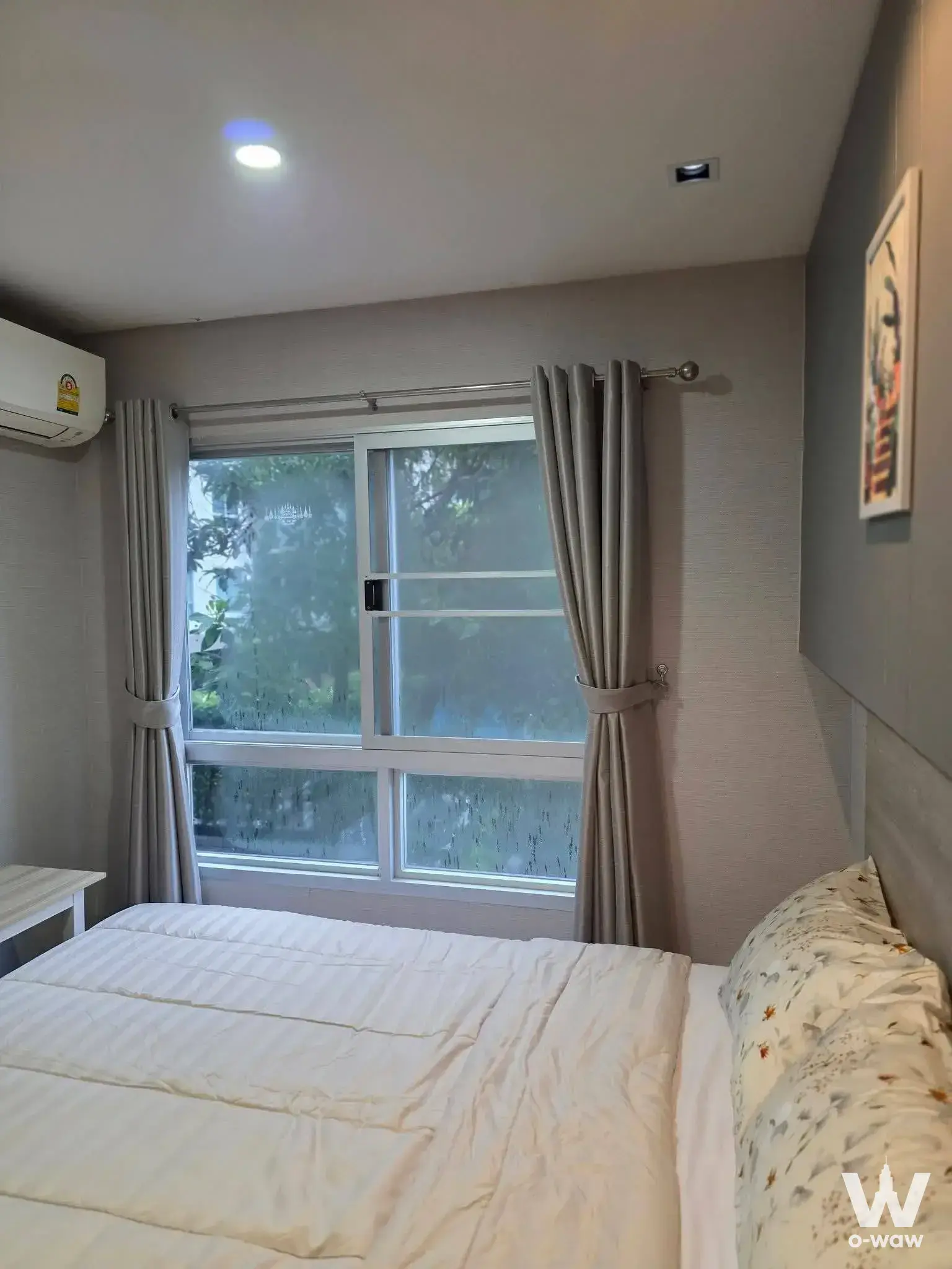 Cozy bedroom in a Lumpini Ville Sukhumvit 76 condo with a queen bed and frosted sliding windows