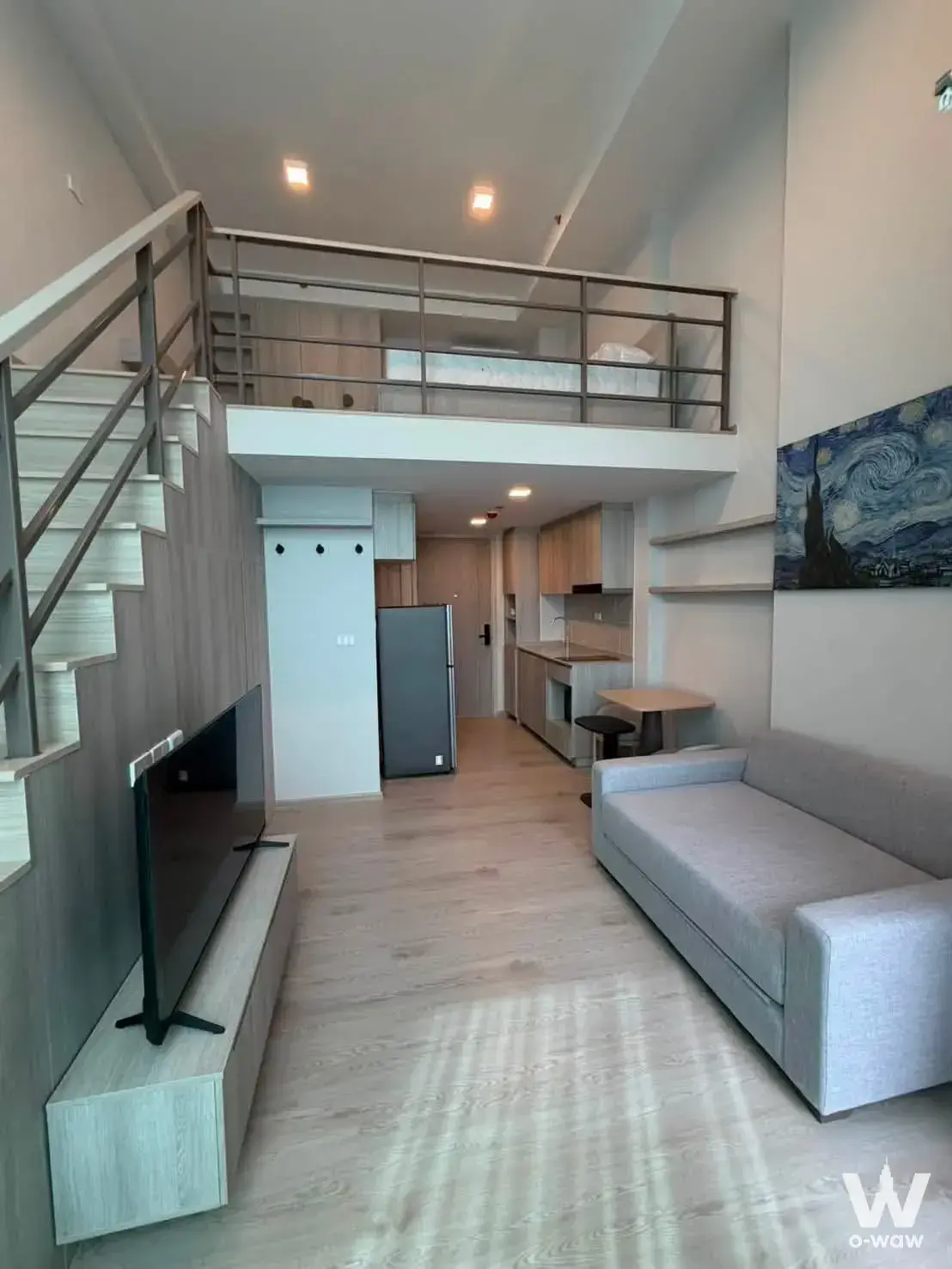 1-bed condo for rent in COBE Kaset-Sripatum featuring a loft-style interior with double-height living area and mezzanine