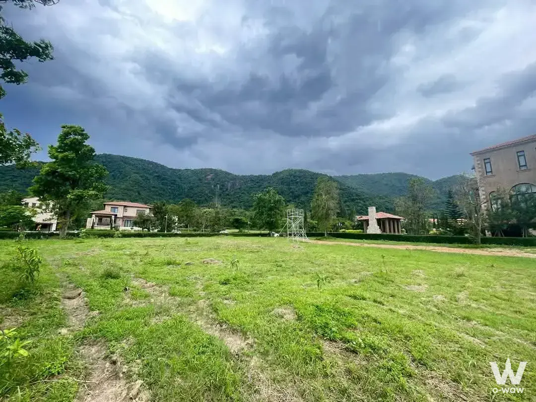 Sprawling lawn and beige villas in Toscana Valley house for sale against mountain backdrop