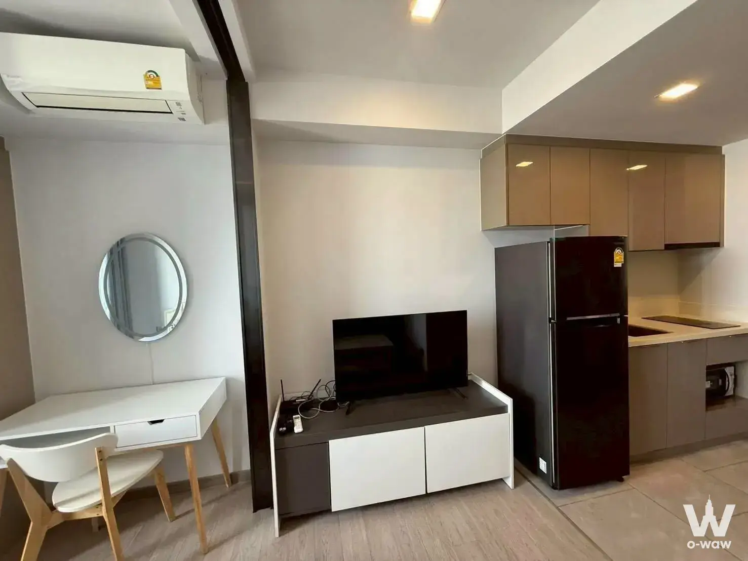 1-bed condo for sale in One9Five Asoke with workspace, grey media console, and kitchenette