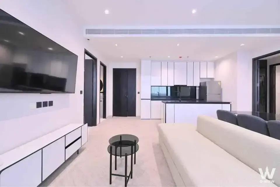 Open-plan living room and kitchen in a 2-bed condo for rent at Chapter Charoennakhon with marble floors and modern finishes