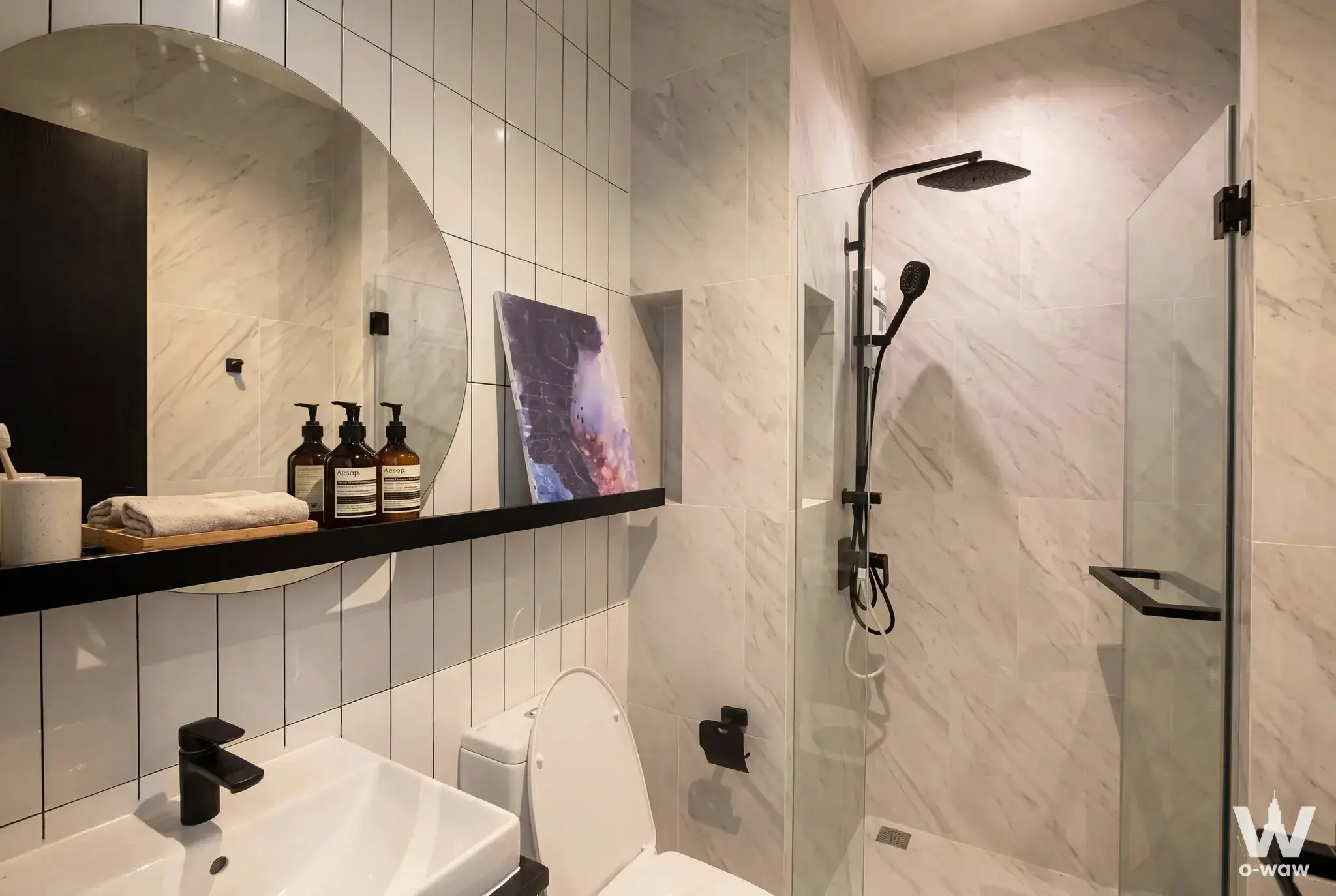 Luxury bathroom with white marble tiles and matte black fixtures in Chapter Charoennakhon