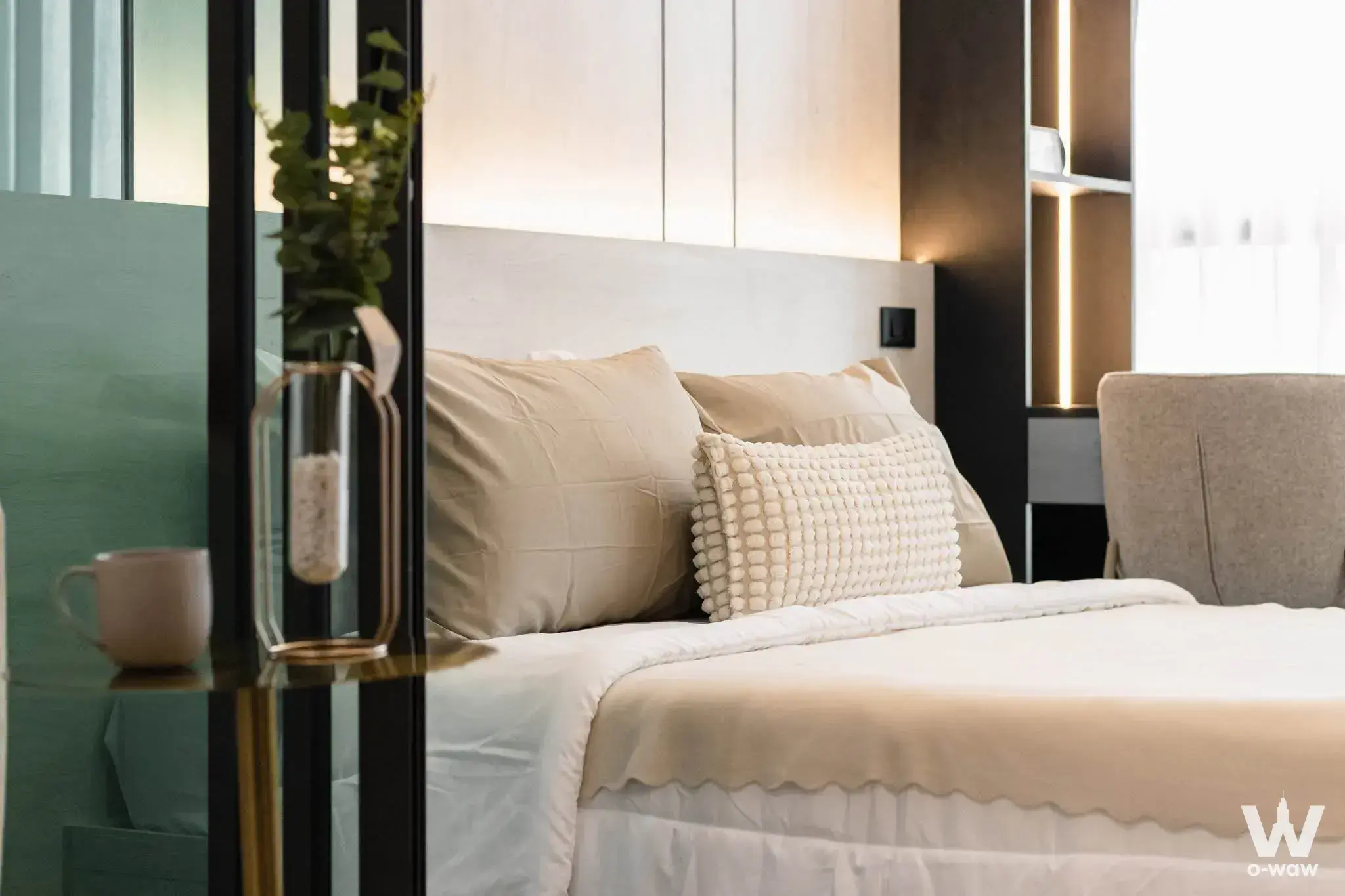 Queen bed with LED-lit cabinetry and sage green wall accents in a Rich Park Terminal Phaholyothin 59 bedroom