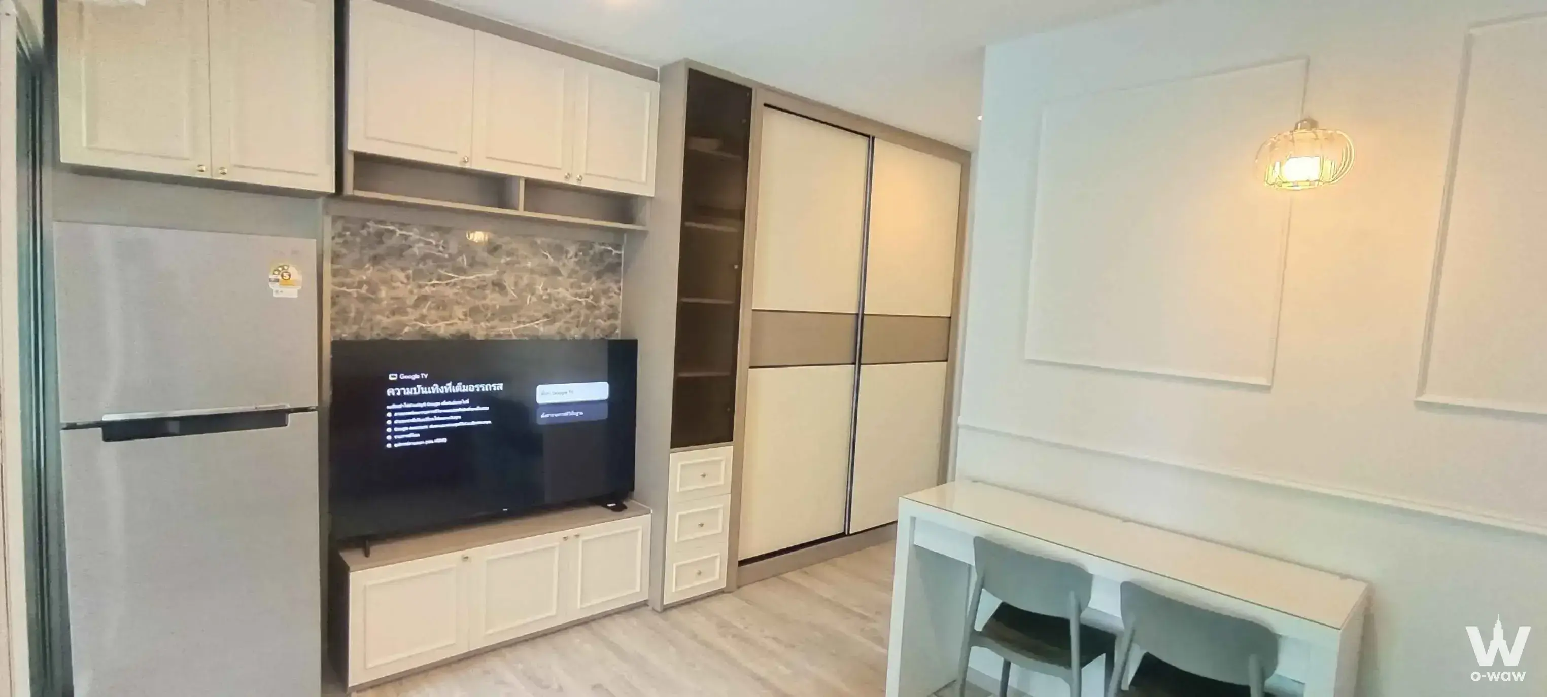 Regent Home Bangna 1-bed condo studio with TV entertainment unit, wardrobe, and dining console