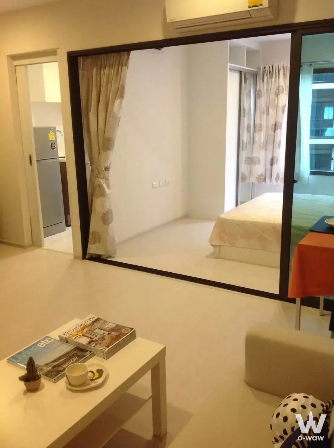 Modern 1-bed condo for rent in Condolette Pixel Sathorn featuring open-plan living area with sliding glass doors to bedroom