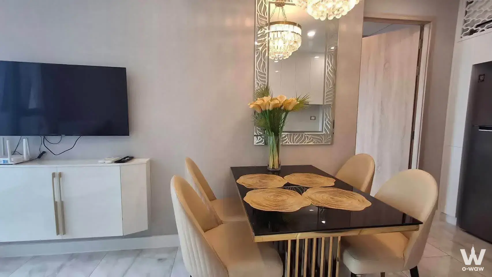 Dining area with black glass table and gold accents at Copacabana Beach Jomtien