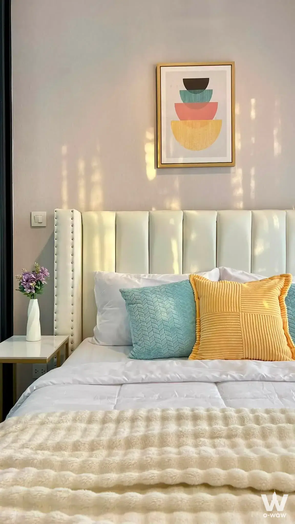 Furnished bedroom in a 1-bed condo for rent at The Politan Rive featuring a queen bed and abstract wall art