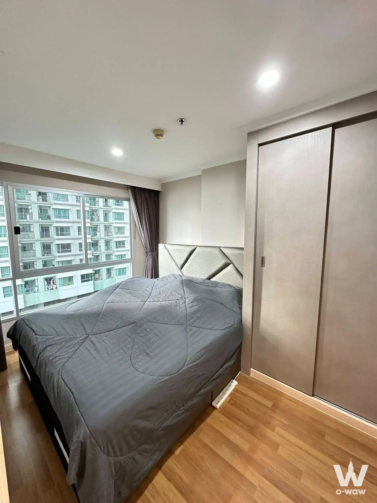 Bedroom with wardrobe and window view at Lumpini Park Riverside Rama 3 1-bed condo for rent