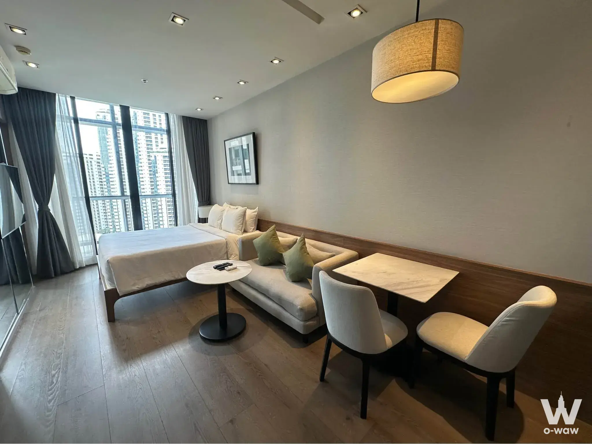 Studio at Park24 featuring queen bed, city view windows, and marble dining table