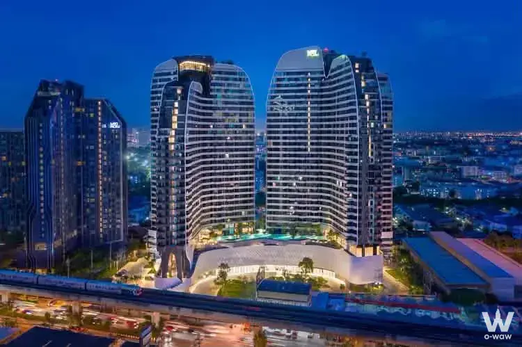 Twilight view of modern high-rise towers and elevated highway in Bangkok city skyline
