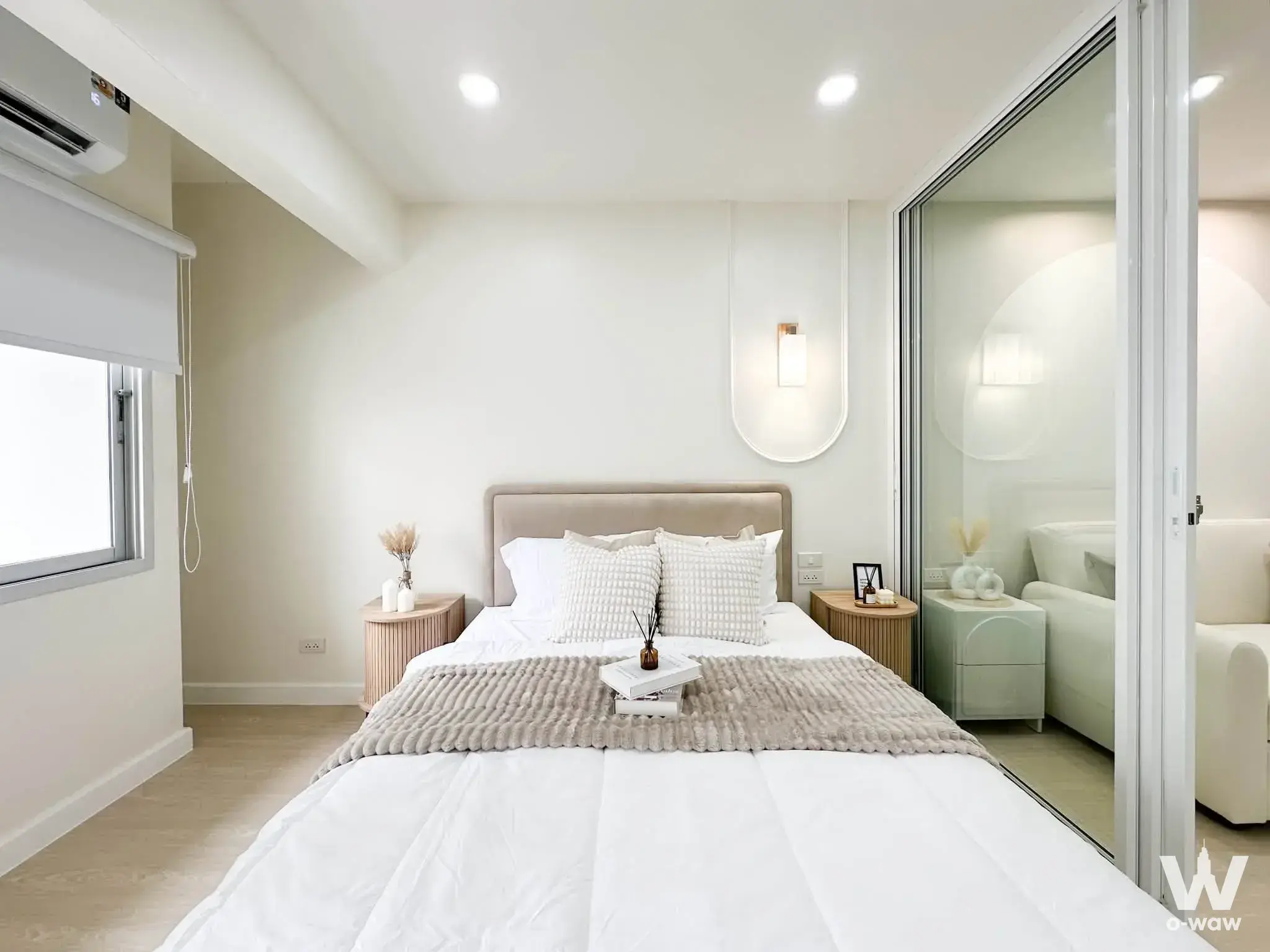Scandinavian-style bedroom with light wood floors and rattan nightstands in Panchasap Suite Condominium