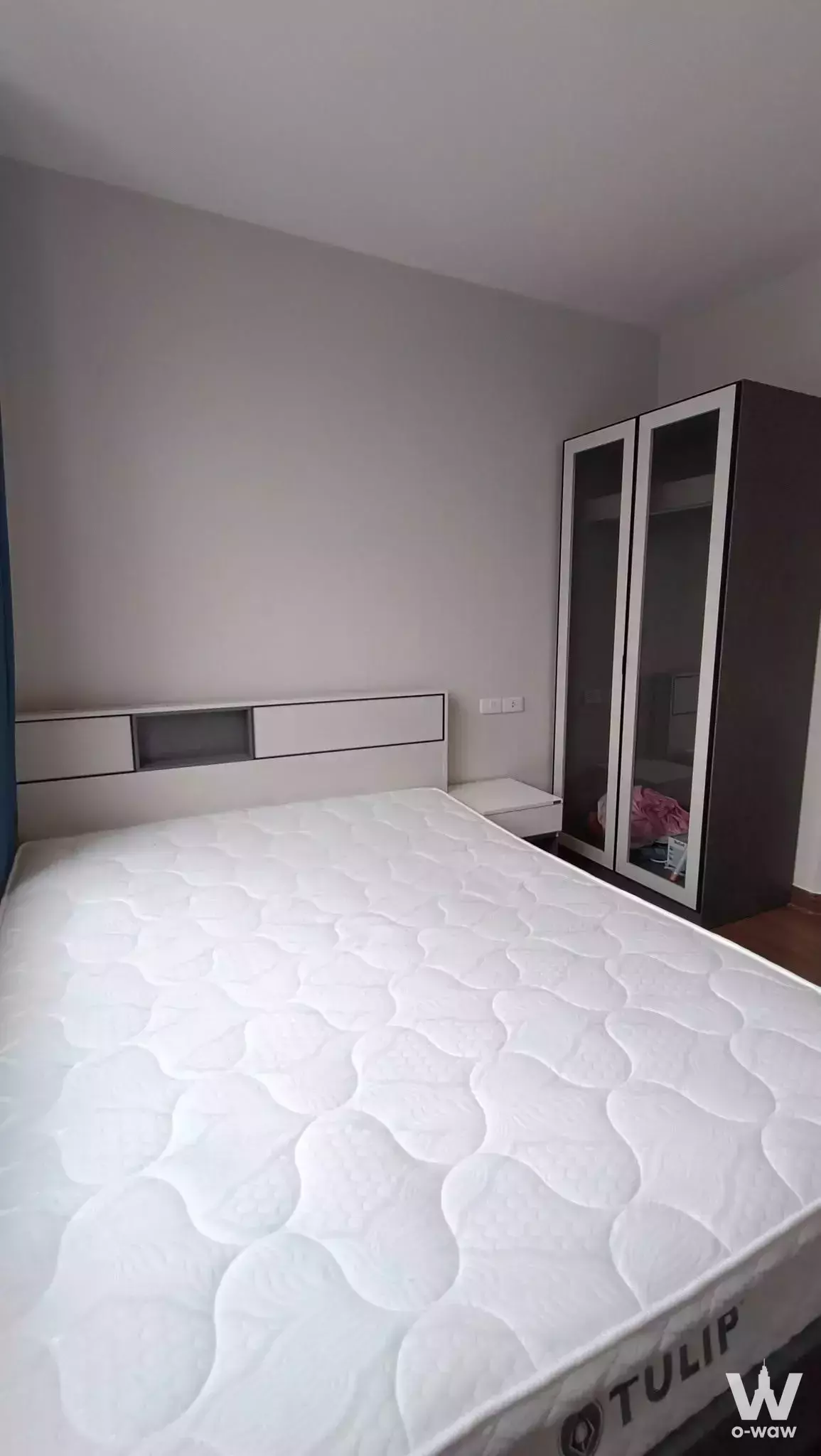Bedroom in an Artisan Ratchada rental with a queen bed and mirrored sliding wardrobe doors