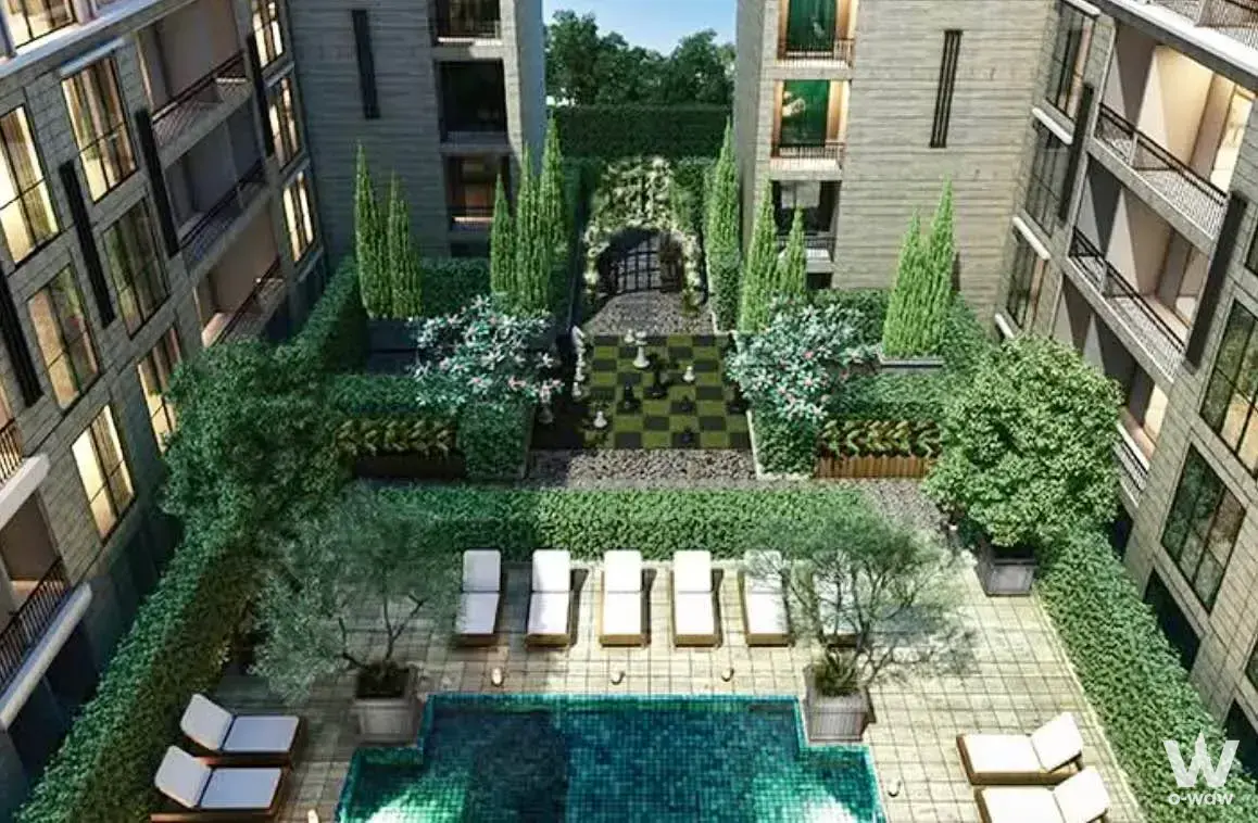 Aerial view of the Maestro 03 Ratchada-Rama 9 courtyard pool with lounge chairs