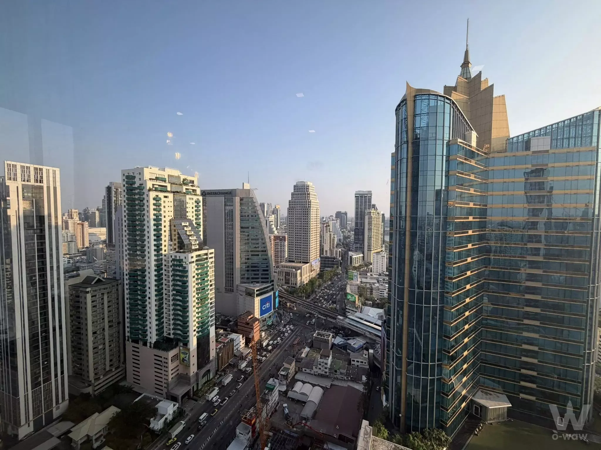 Bangkok skyline view from Ashton Asoke 2-bed rental showing glass towers and highway traffic