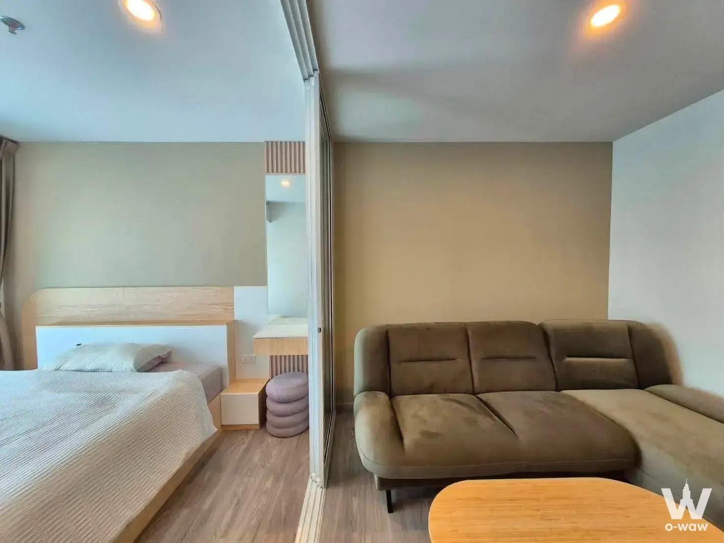 Regent Home Bangna studio apartment with sliding glass partition separating bed and living areas